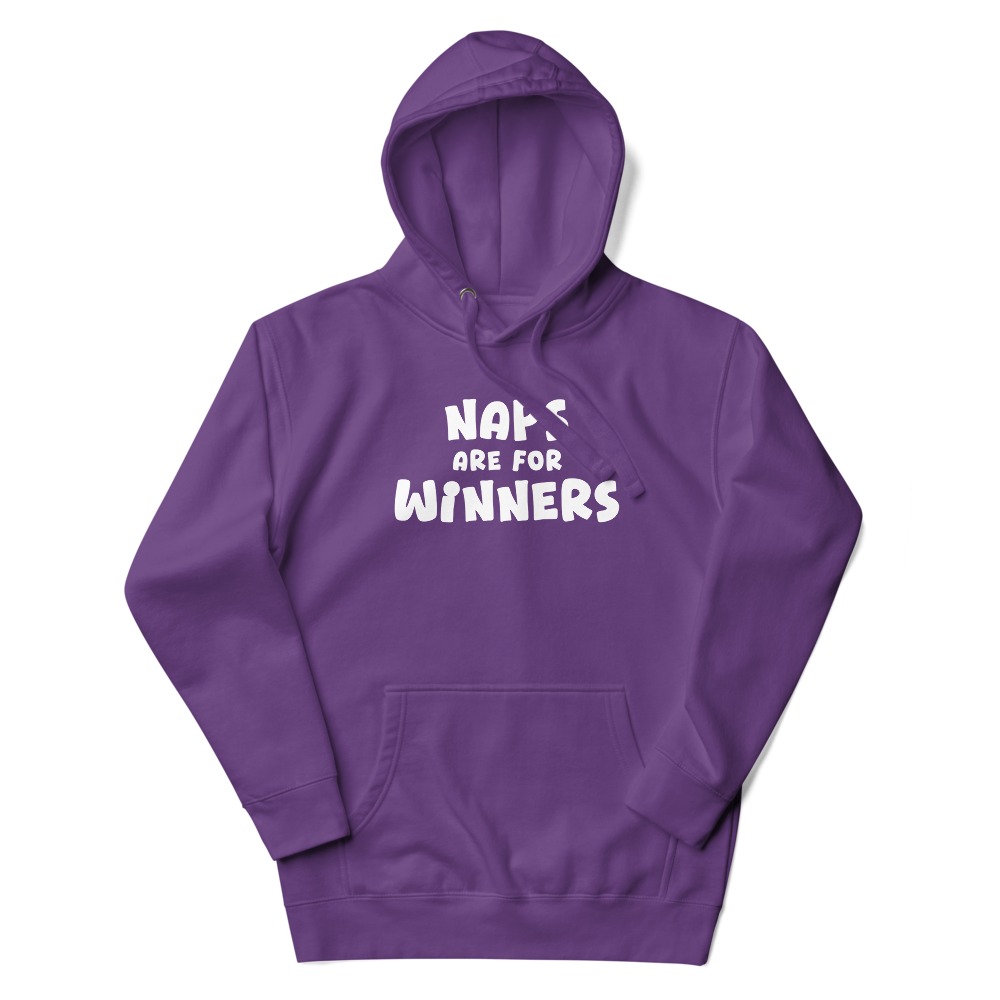 "Naps Are For Winners" printed on a purple unisex hoodie laying on a flat surface with the hood up