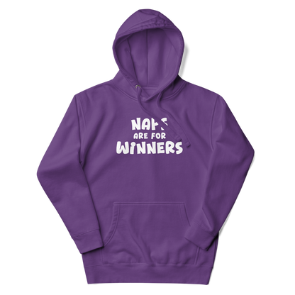 "Naps Are For Winners" printed on a purple unisex hoodie laying on a flat surface with the hood up