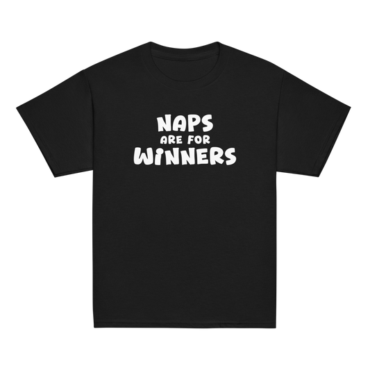 "Naps Are For Winners" printed on a black youth classic tee laying on a flat surface