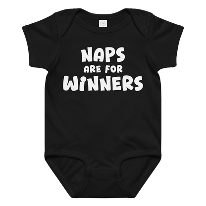 "Naps Are For Winners" printed on a black baby jersey bodysuit laying on a flat surface amongst other clothes