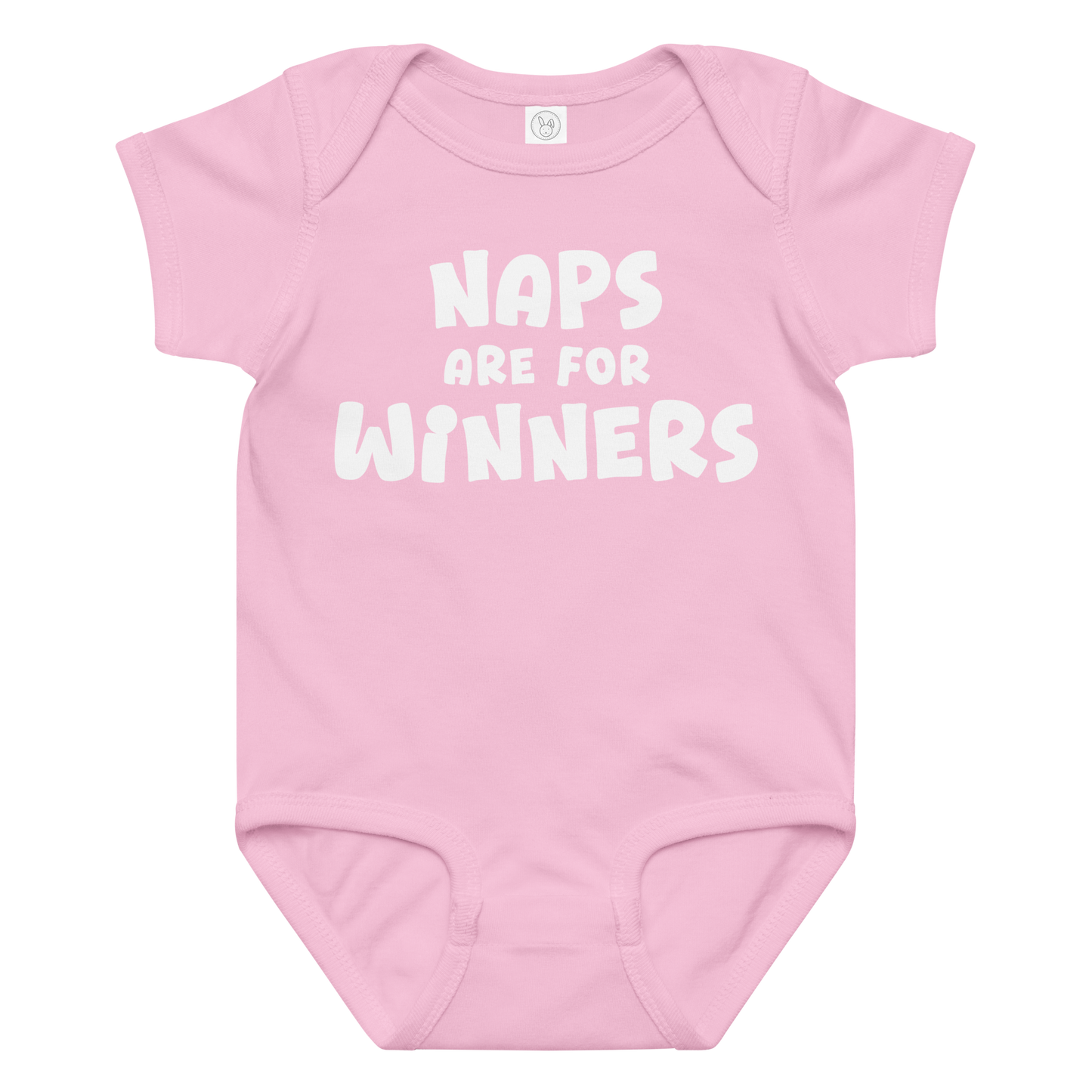 "Naps Are For Winners" printed on a pink baby jersey bodysuit laying on a flat surface amongst other clothes