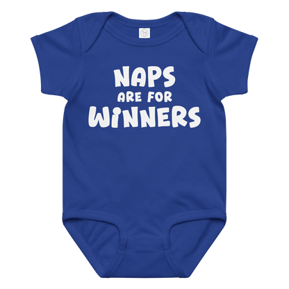 "Naps Are For Winners" printed on a royal baby jersey bodysuit laying on a flat surface amongst other clothes