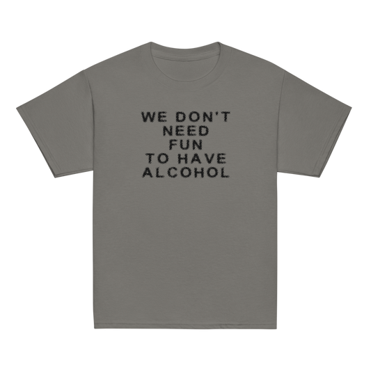 "We don’t need fun to have alcohol" printed on a charcoal youth classic tee laying on a flat surface