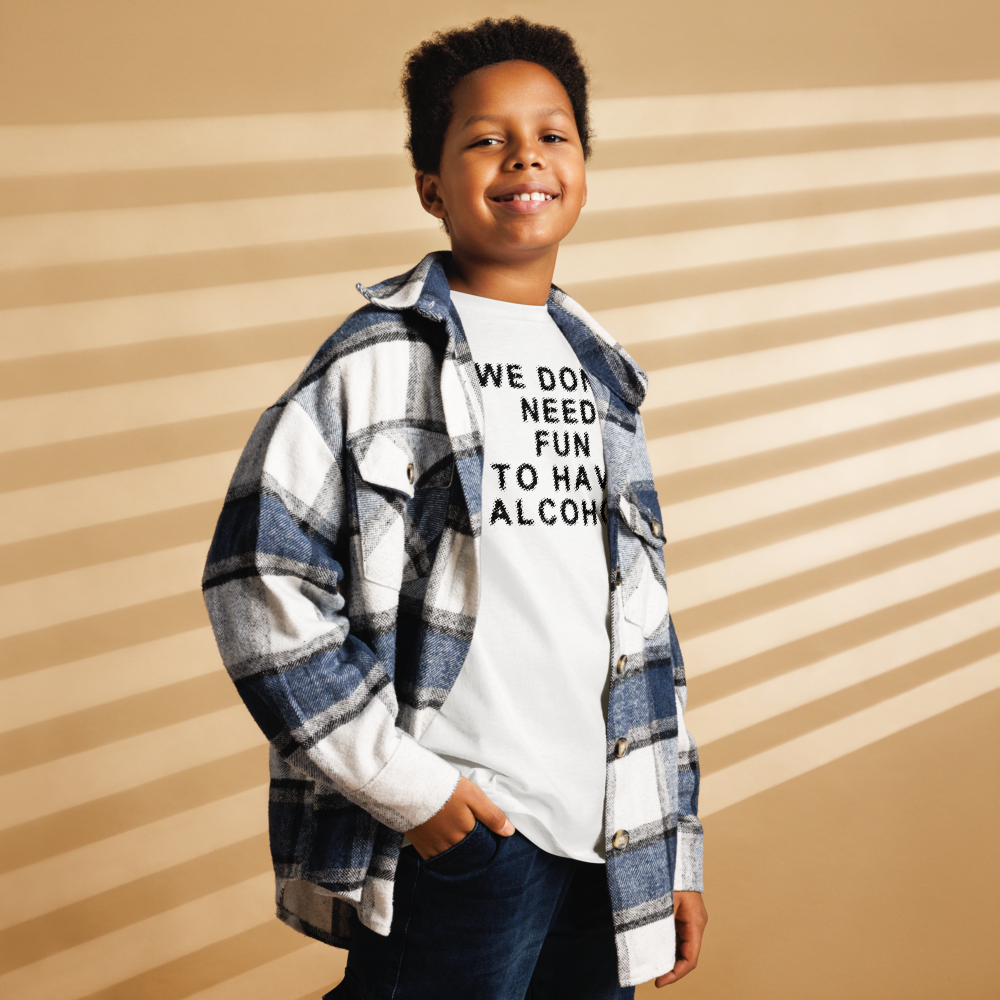 "We don’t need fun to have alcohol" printed on a white youth classic tee worn by a male also wearing a jacket