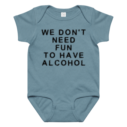 "We don’t need fun to have alcohol" printed on a vintage indigo baby jersey bodysuit laying on a flat surface amongst other clothes