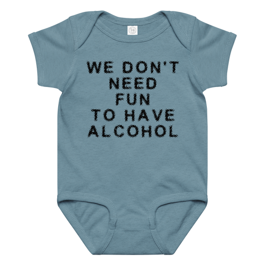 "We don’t need fun to have alcohol" printed on a vintage indigo baby jersey bodysuit laying on a flat surface amongst other clothes