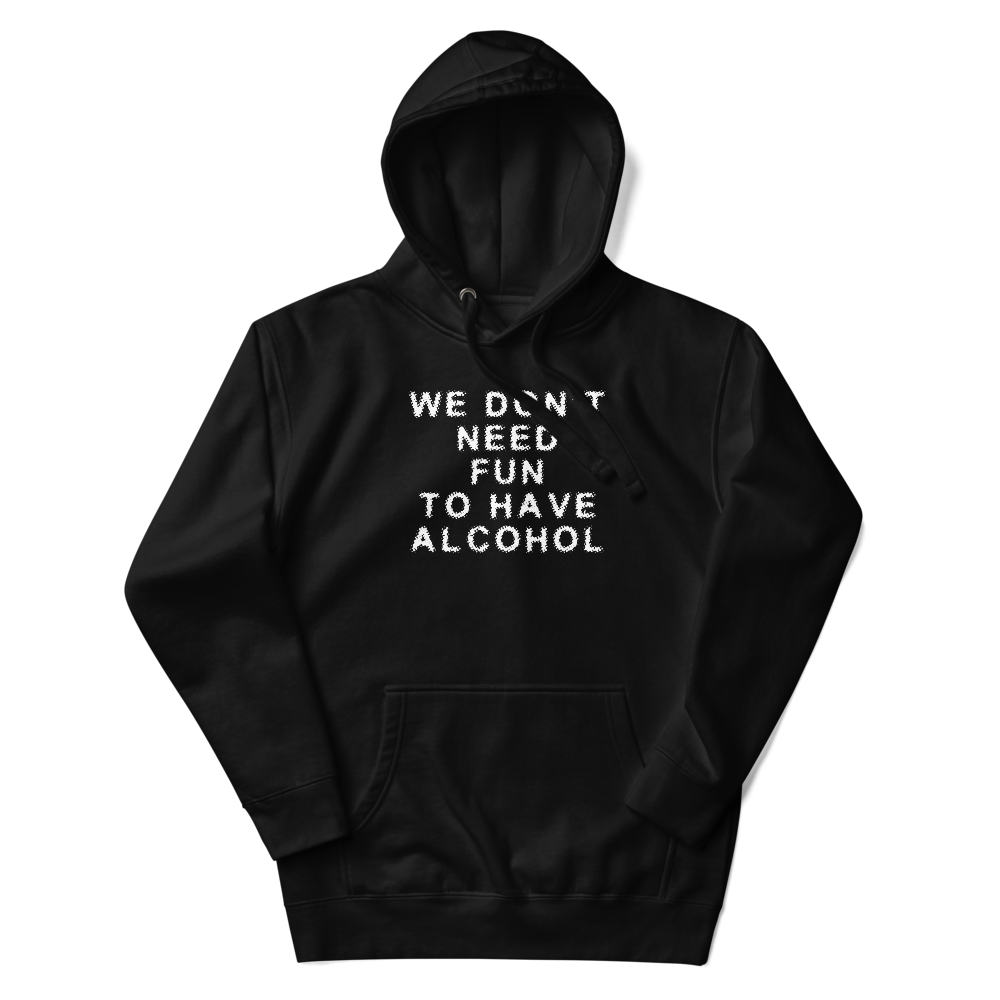 "We don’t need fun to have alcohol" printed on a black unisex hoodie laying on a flat surface with the hood up