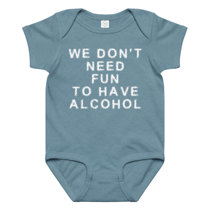 "We don’t need fun to have alcohol" printed on a vintage indigo baby jersey bodysuit laying on a flat surface amongst other clothes