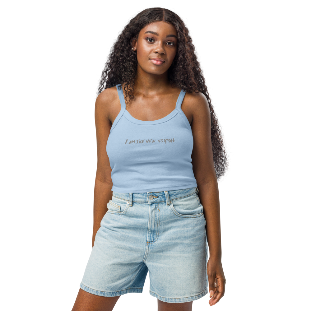 "I am the new normal" printed on a solid baby blue blend women's micro-rib tanktop worn by a female