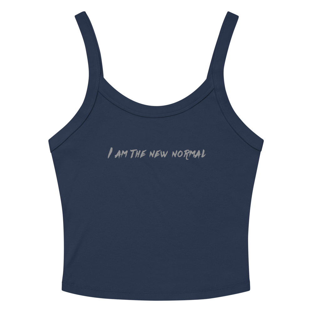 "I am the new normal" printed on a solid navy blend women's micro-rib tanktop laying on a flat surface amongst sunglasses and shorts