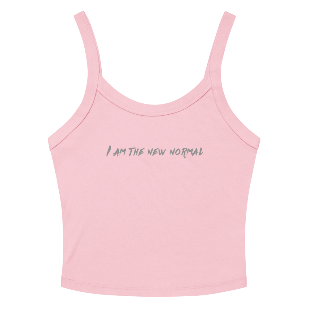 "I am the new normal" printed on a solid pink blend women's micro-rib tanktop laying on a flat surface amongst sunglasses and shorts