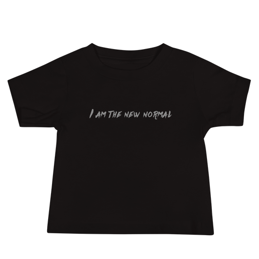 "I am the new normal" printed on a black baby jersey short sleeve tee laying on a flat surface