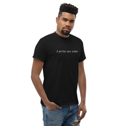 "I am the new normal" printed on a black unisex classic tee worn by a male