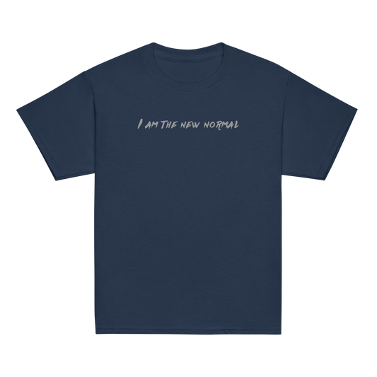 "I am the new normal" printed on a navy youth classic tee laying on a flat surface