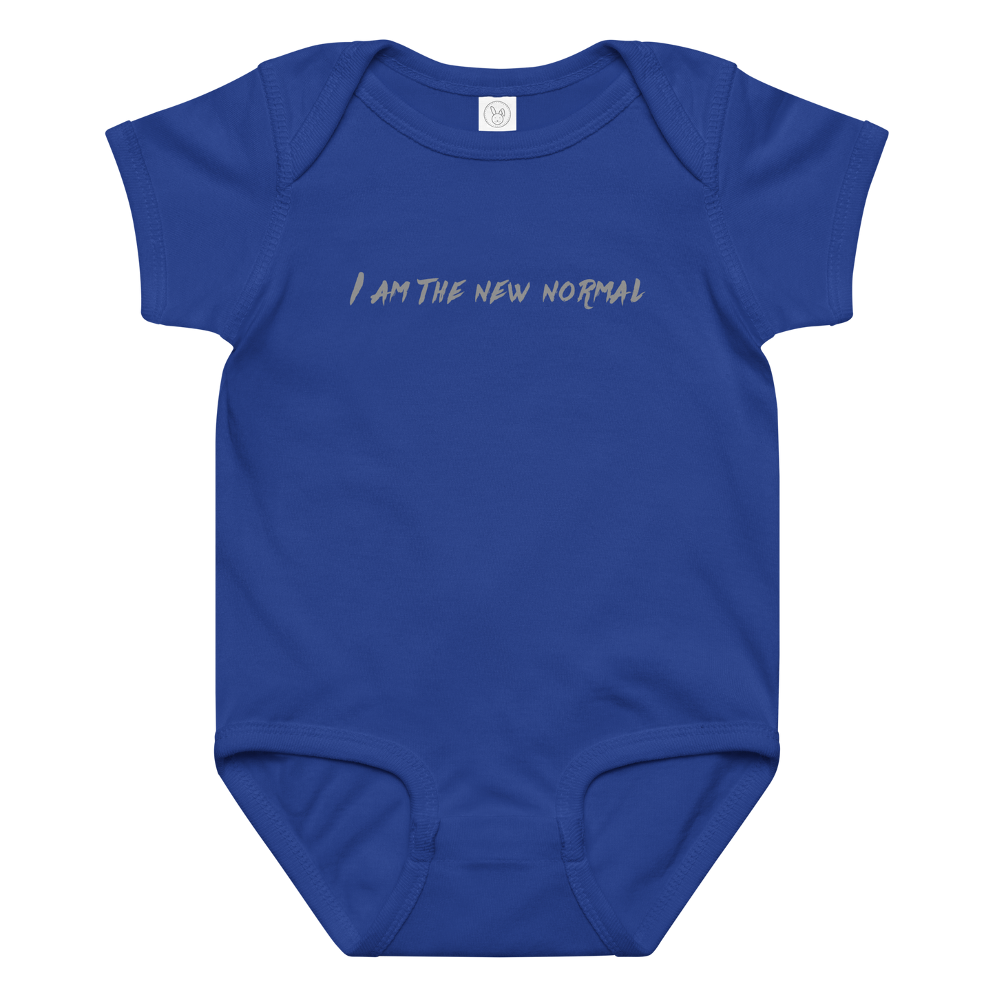 "I am the new normal" printed on a royal baby jersey bodysuit laying on a flat surface amongst other clothes