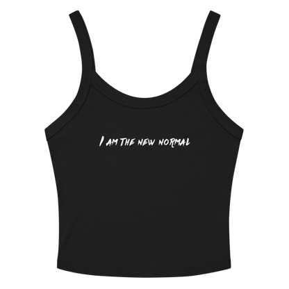 "I am the new normal" printed on a solid black blend women's micro-rib tanktop laying on a flat surface amongst sunglasses and shorts