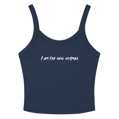 "I am the new normal" printed on a solid navy blend women's micro-rib tanktop laying on a flat surface amongst sunglasses and shorts