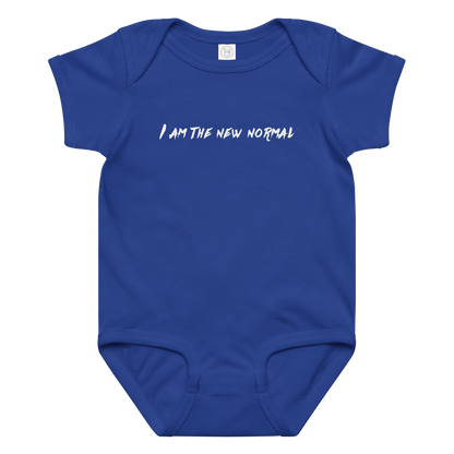 "I am the new normal" printed on a royal baby jersey bodysuit laying on a flat surface amongst other clothes