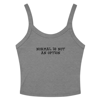 "Normal is not an option" printed on a athletic heather women's micro-rib tanktop laying on a flat surface amongst sunglasses and shorts