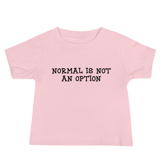 "Normal is not an option" printed on a pink baby jersey short sleeve tee laying on a flat surface