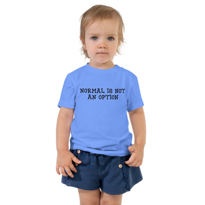 "Normal is not an option" printed on a heather columbia blue toddler short sleeve tee worn by a female