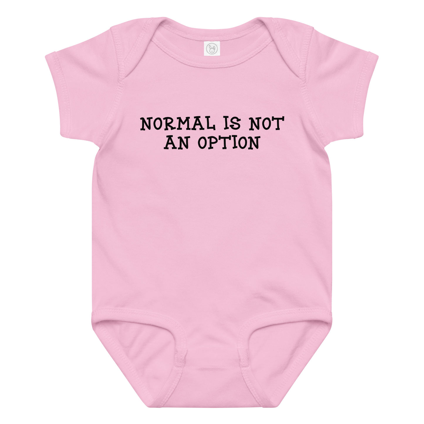 "Normal is not an option" printed on a pink baby jersey bodysuit laying on a flat surface amongst other clothes