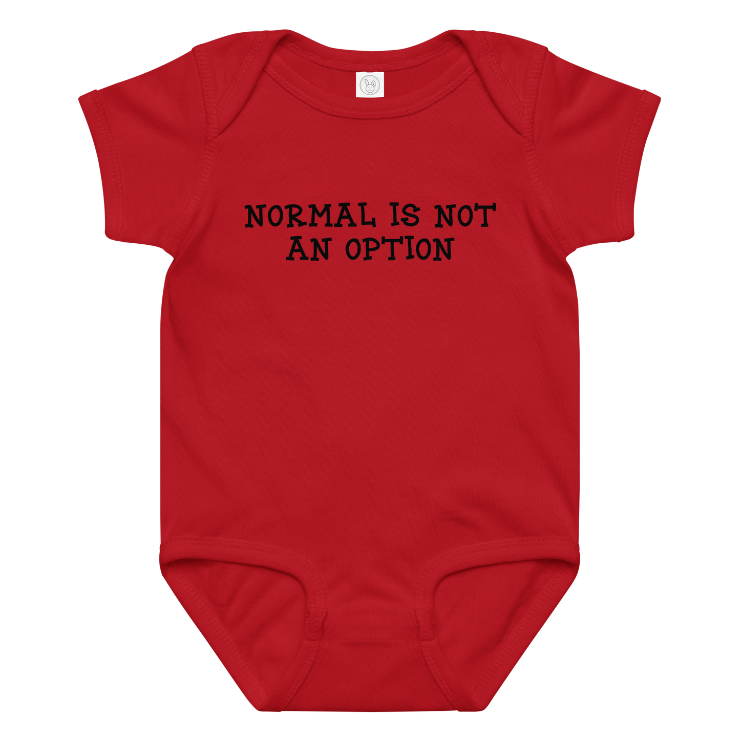"Normal is not an option" printed on a red baby jersey bodysuit laying on a flat surface amongst other clothes