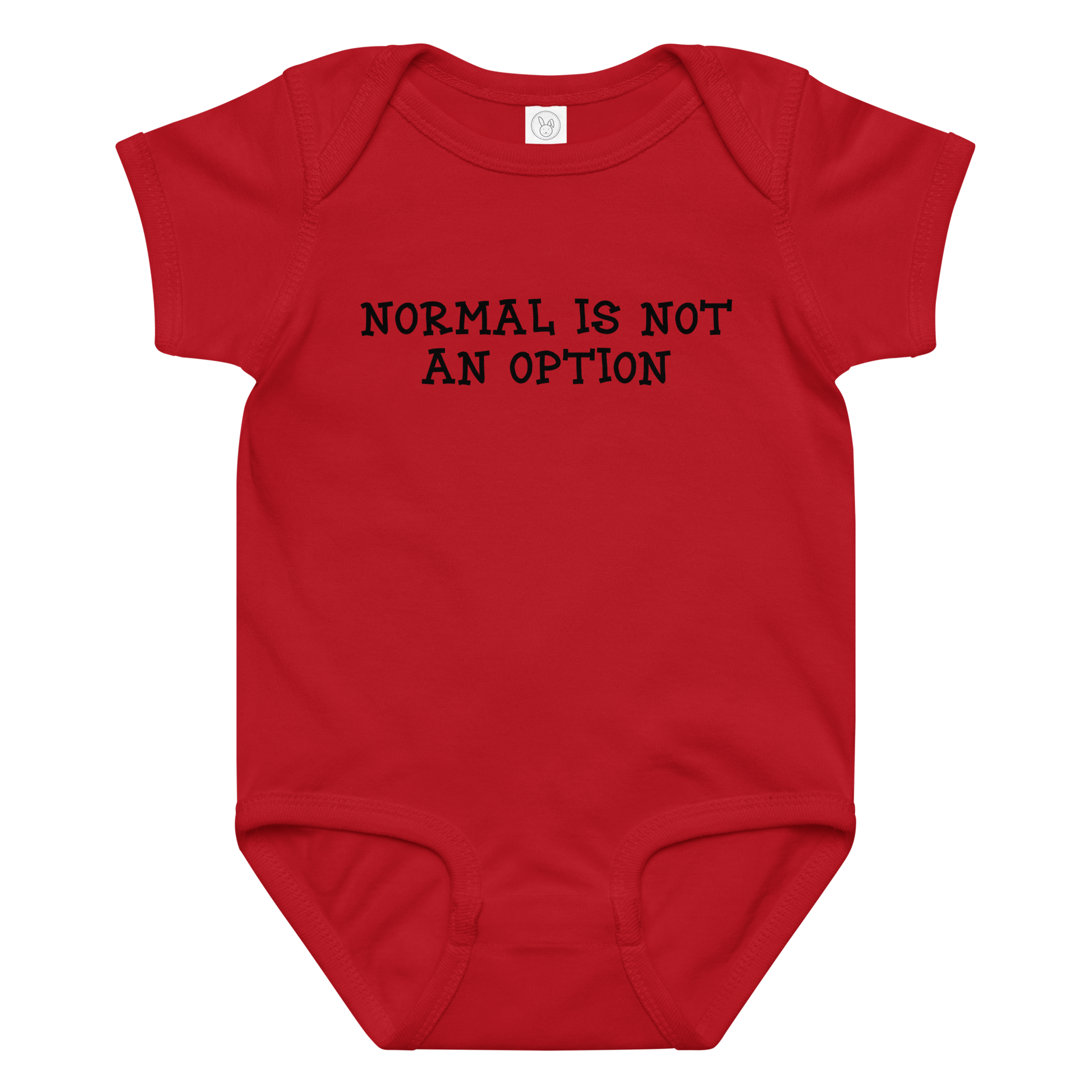 "Normal is not an option" printed on a red baby jersey bodysuit laying on a flat surface amongst other clothes