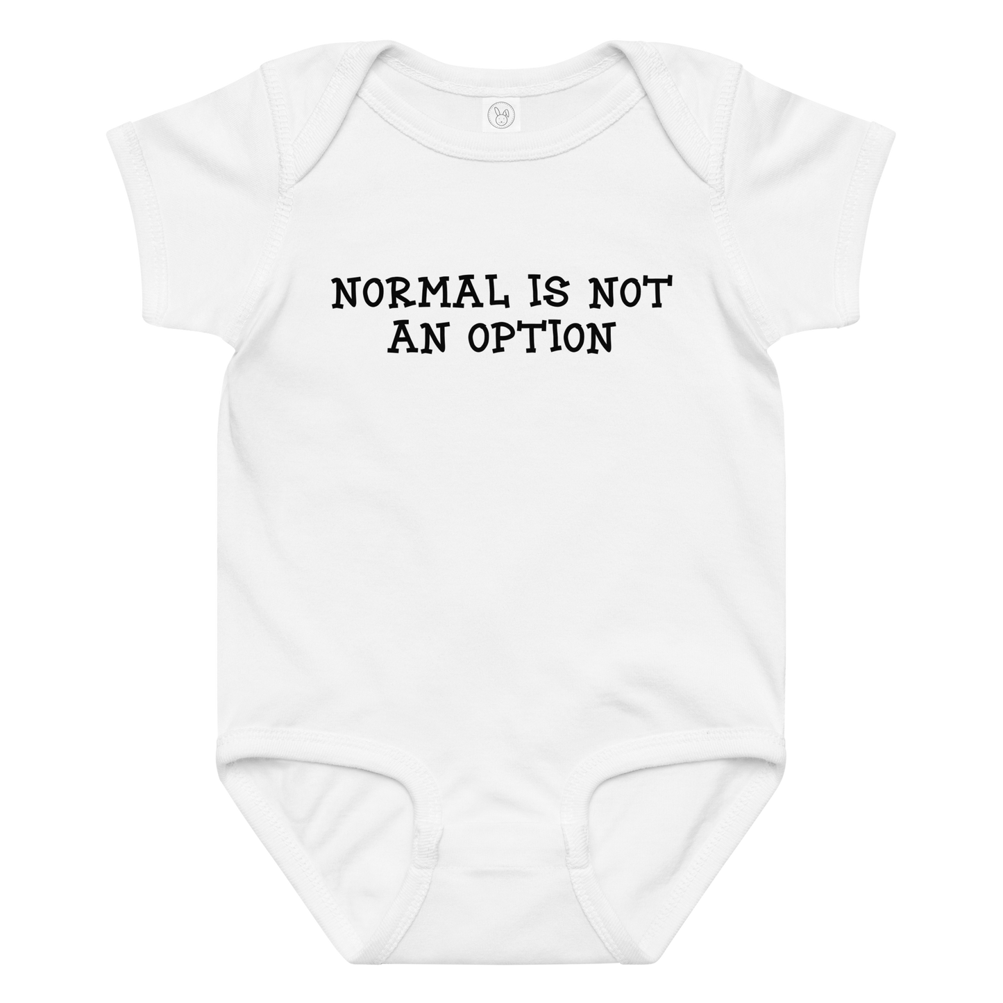 "Normal is not an option" printed on a white baby jersey bodysuit laying on a flat surface amongst other clothes