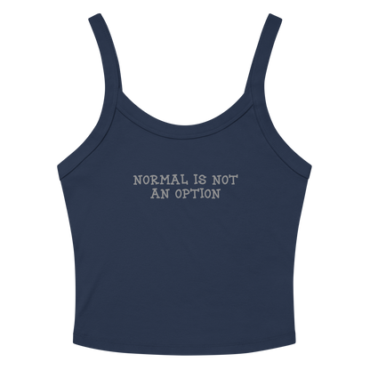 "Normal is not an option" printed on a solid navy blend women's micro-rib tanktop laying on a flat surface amongst sunglasses and shorts
