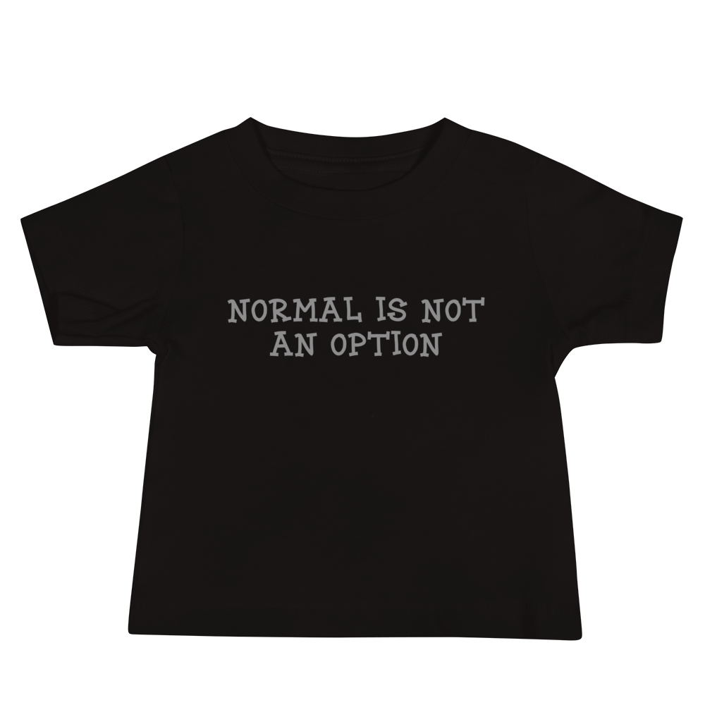 "Normal is not an option" printed on a black baby jersey short sleeve tee laying on a flat surface