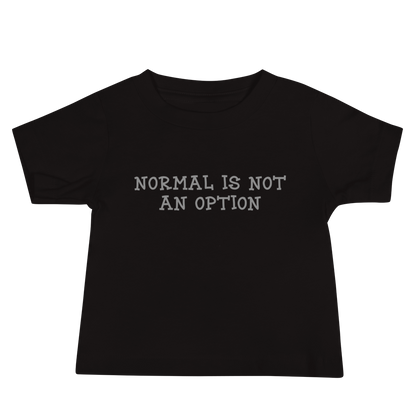 "Normal is not an option" printed on a black baby jersey short sleeve tee laying on a flat surface