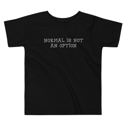 "Normal is not an option" printed on a black toddler short sleeve tee laying on a flat surface