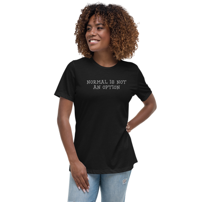 "Normal is not an option" printed on a black women's relaxed t-shirt worn by a female
