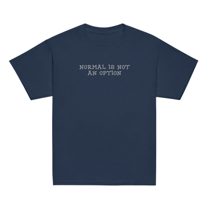 "Normal is not an option" printed on a navy youth classic tee laying on a flat surface