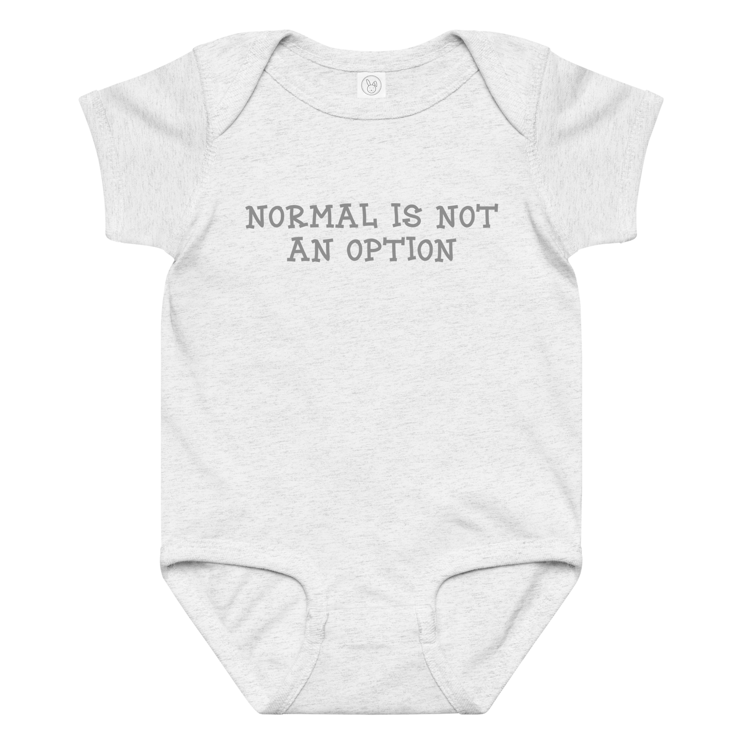 "Normal is not an option" printed on a ash baby jersey bodysuit laying on a flat surface amongst other clothes
