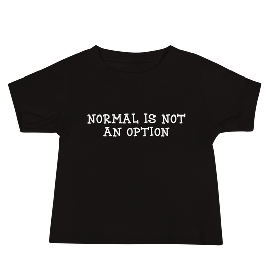 "Normal is not an option" printed on a black baby jersey short sleeve tee laying on a flat surface