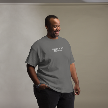 "Normal is not an option" printed on a charcoal unisex classic tee worn by a male