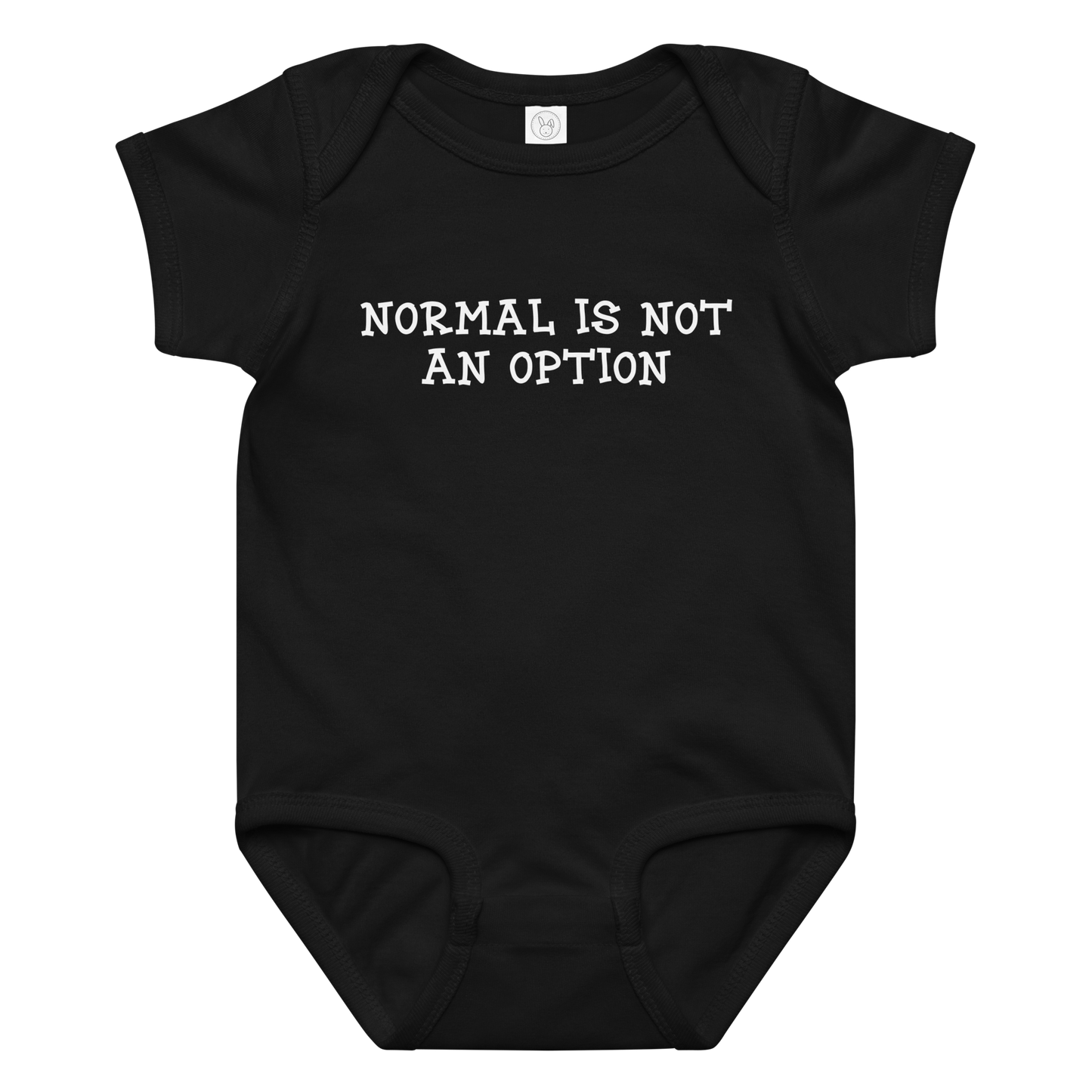 "Normal is not an option" printed on a black baby jersey bodysuit laying on a flat surface amongst other clothes