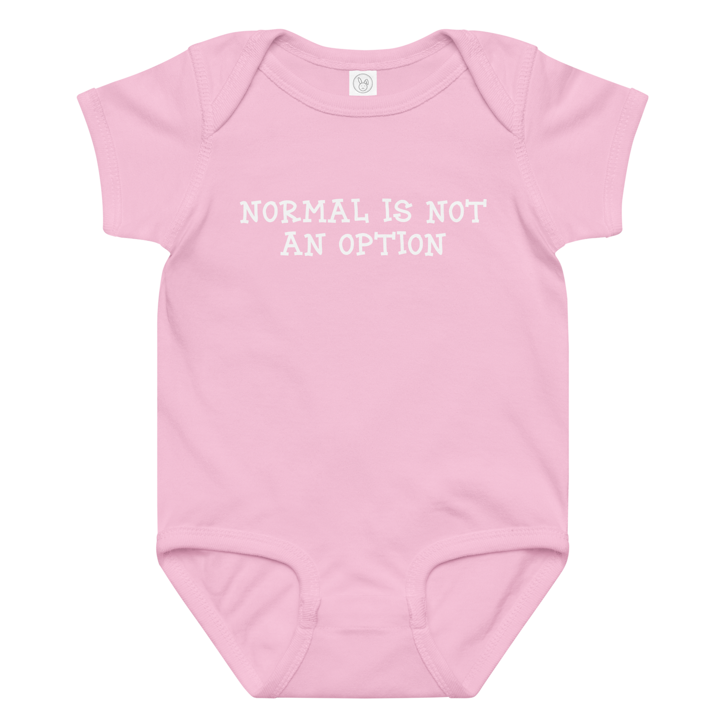 "Normal is not an option" printed on a pink baby jersey bodysuit laying on a flat surface amongst other clothes