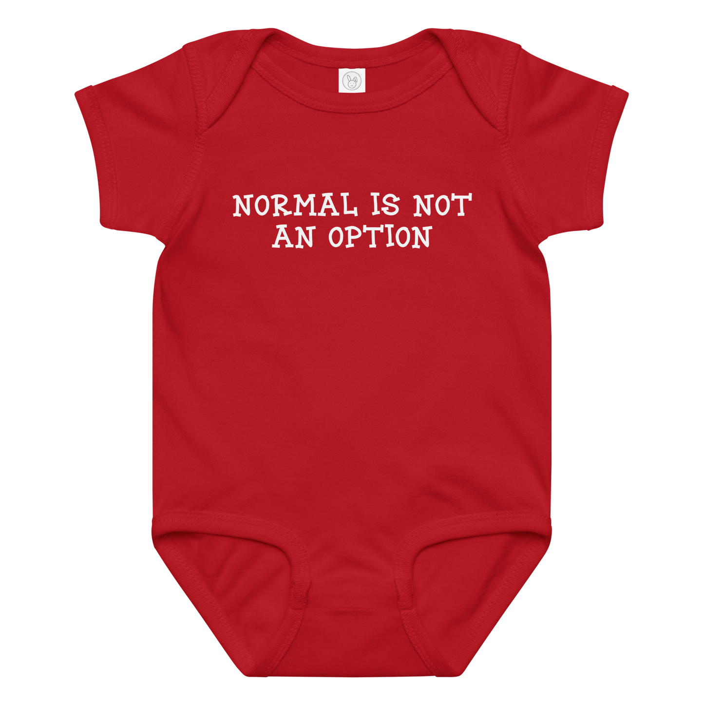 "Normal is not an option" printed on a red baby jersey bodysuit laying on a flat surface amongst other clothes