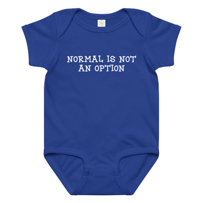 "Normal is not an option" printed on a royal baby jersey bodysuit laying on a flat surface amongst other clothes