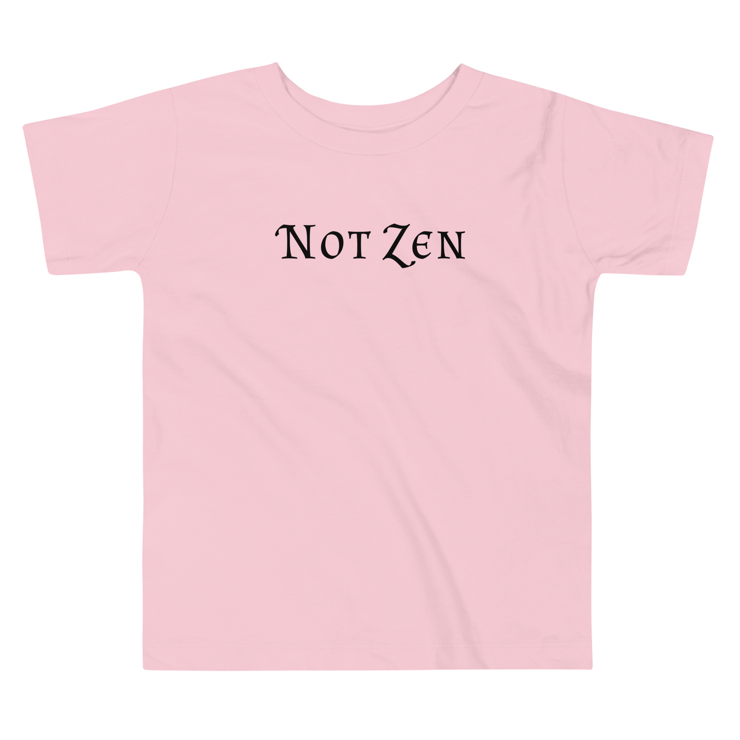 "Not zen" printed on a pink toddler short sleeve tee laying on a flat surface