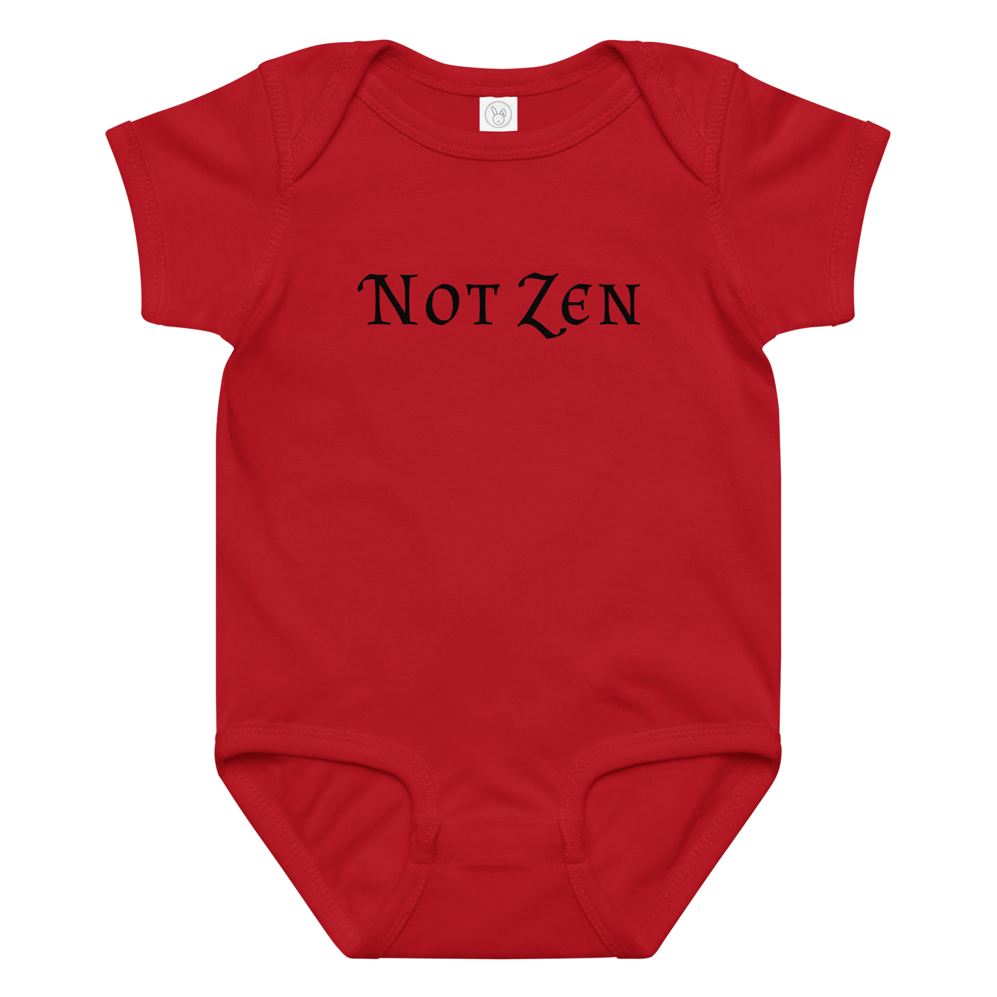 "Not zen" printed on a red baby jersey bodysuit laying on a flat surface amongst other clothes