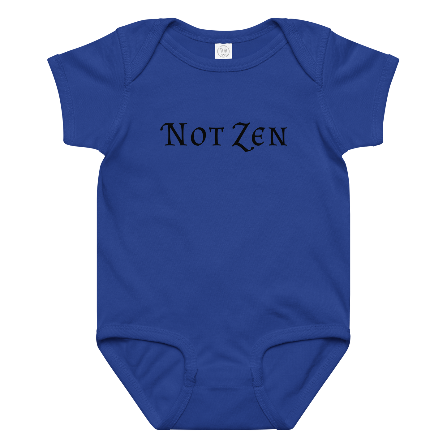 "Not zen" printed on a royal baby jersey bodysuit laying on a flat surface amongst other clothes