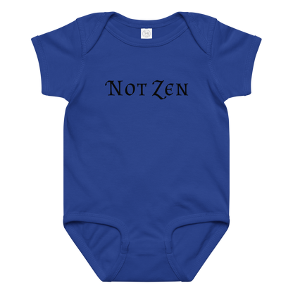 "Not zen" printed on a royal baby jersey bodysuit laying on a flat surface amongst other clothes
