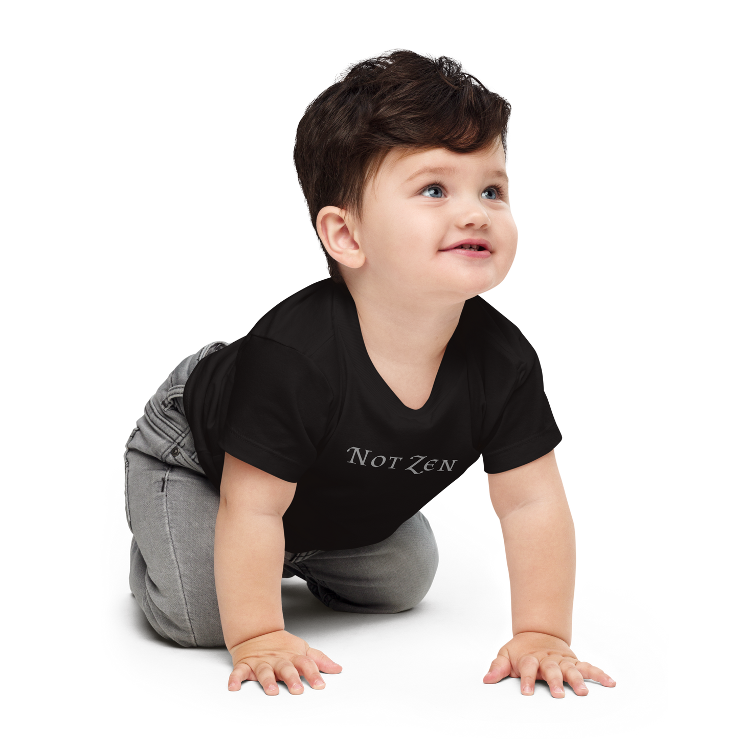"Not zen" printed on a black baby jersey short sleeve tee worn by a male who is crawling