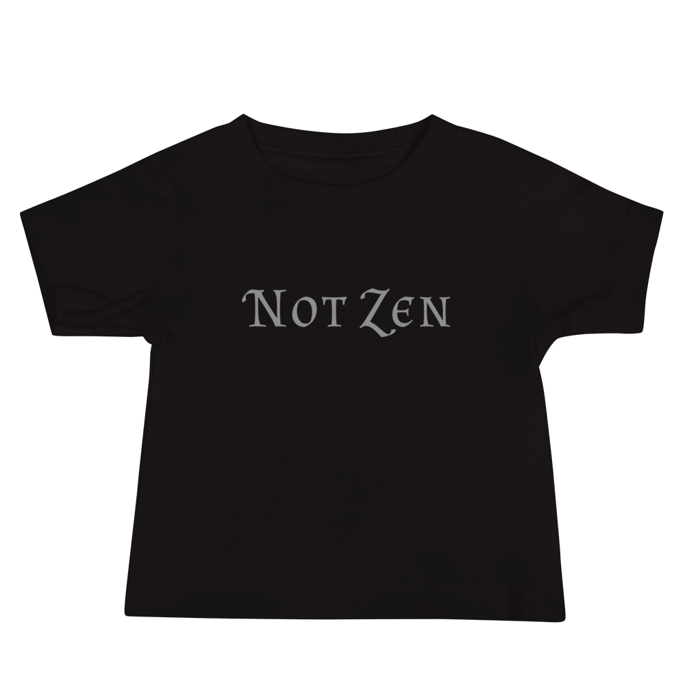 "Not zen" printed on a black baby jersey short sleeve tee laying on a flat surface