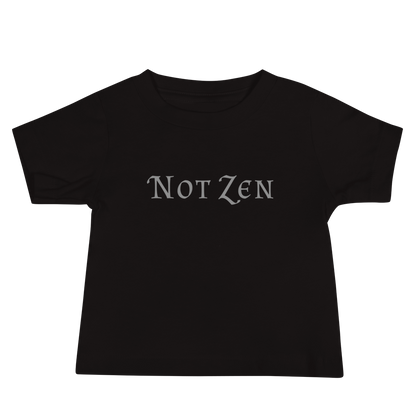 "Not zen" printed on a black baby jersey short sleeve tee laying on a flat surface