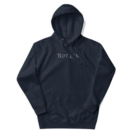 "Not zen" printed on a navy blazer unisex hoodie laying on a flat surface with the hood up